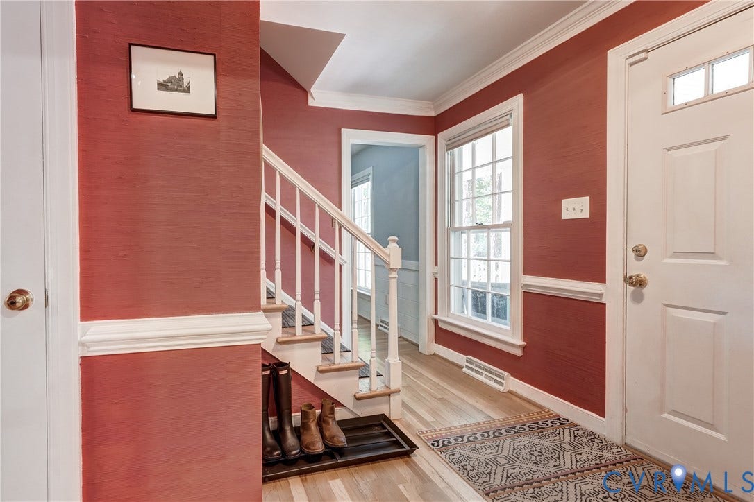 5 Bridgehampton Place, Yorkshire, Henrico, VA 23229 Foyer featuring textured wall finish, wood-finish flooring, white millwork including crown molding and chair rail, staircase with white balusters, and a paneled entry door with transom light