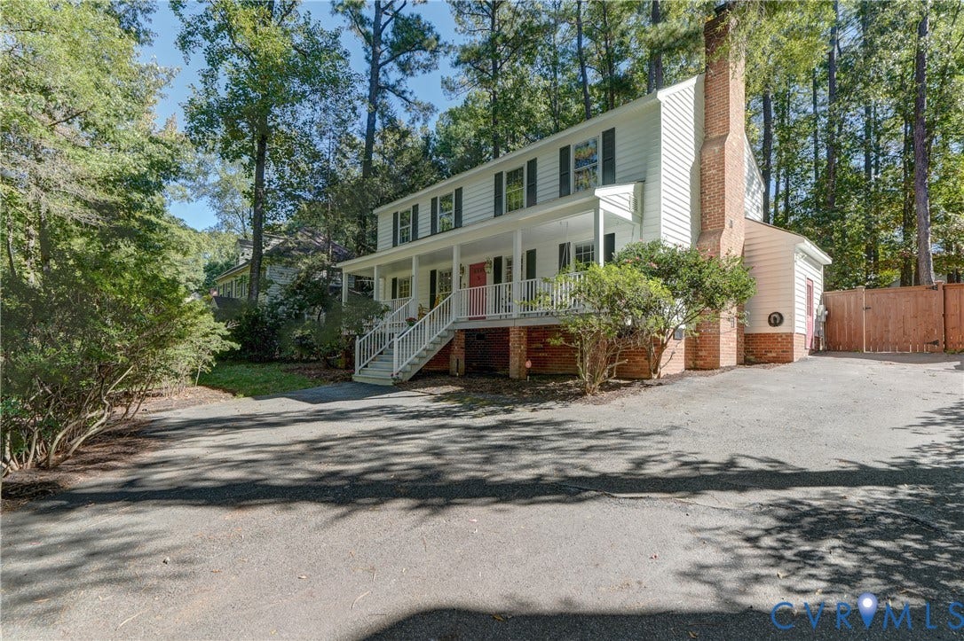 5 Bridgehampton Place, Yorkshire, Henrico, VA 23229 Two-story colonial exterior featuring a brick chimney, raised front porch with white railing, and exterior shutters