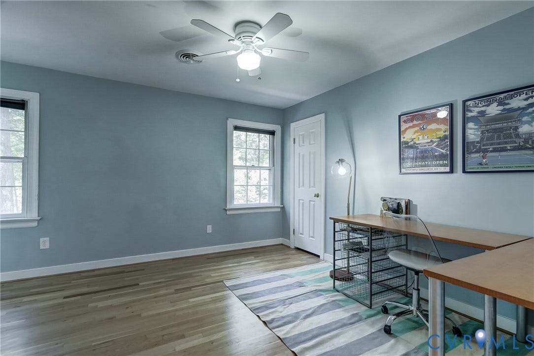 5 Bridgehampton Place, Yorkshire, Henrico, VA 23229 Room with wood-finish flooring, white-painted six-panel door, multi-pane windows, and a central ceiling fan with integrated lighting