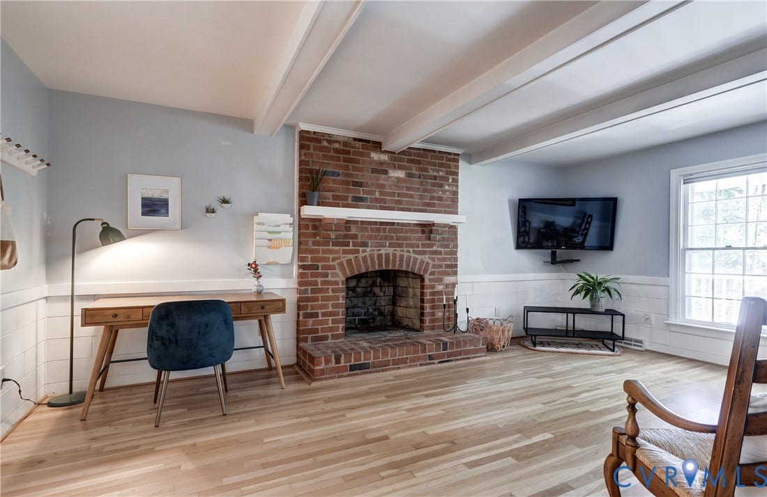 5 Bridgehampton Place, Yorkshire, Henrico, VA 23229 Exposed wood ceiling beams, red brick fireplace with a mantel, horizontal wood wall paneling, and light-toned wood-finish flooring