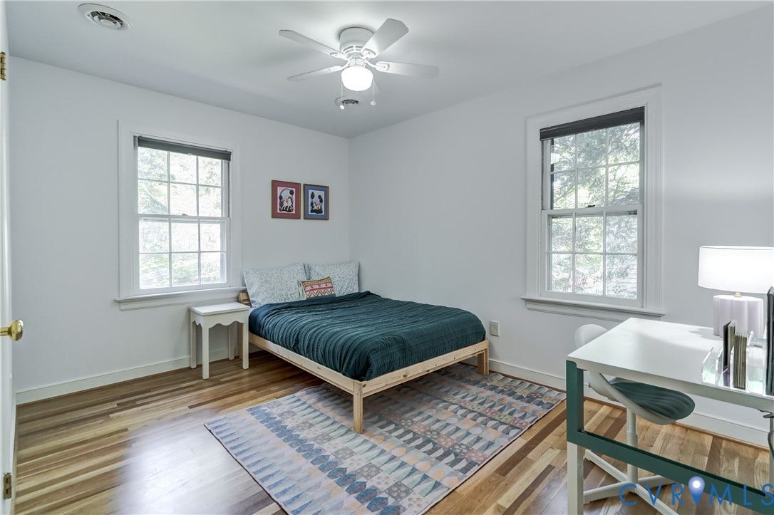5 Bridgehampton Place, Yorkshire, Henrico, VA 23229 Room featuring wood-finish flooring, two double-hung windows with muntins, and a ceiling-mounted light fixture with a fan