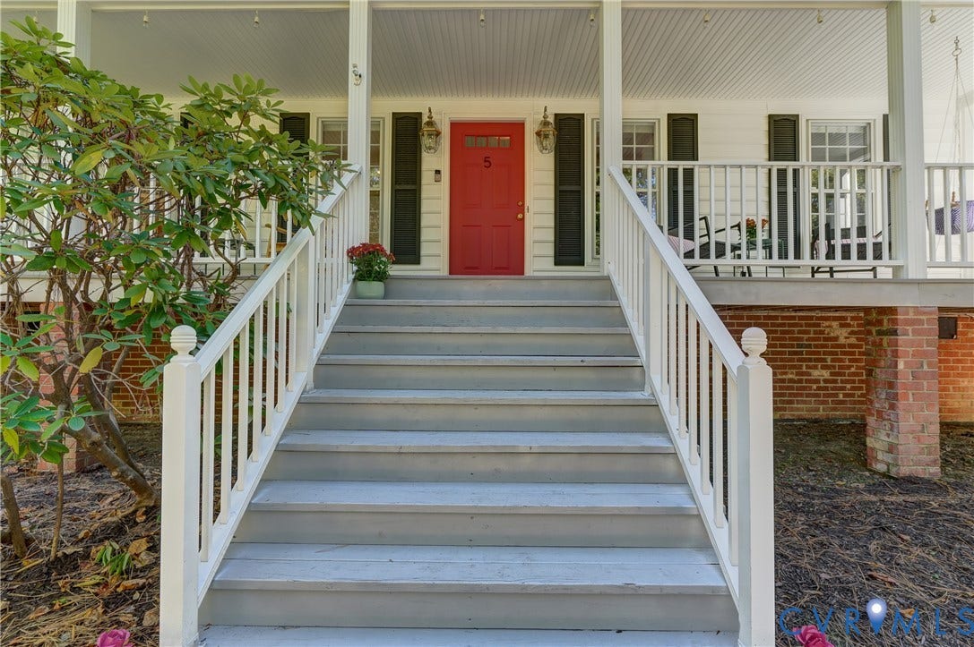 5 Bridgehampton Place, Yorkshire, Henrico, VA 23229 Covered front porch featuring white railing, brick foundation detailing, wide staircase, and a central paneled door