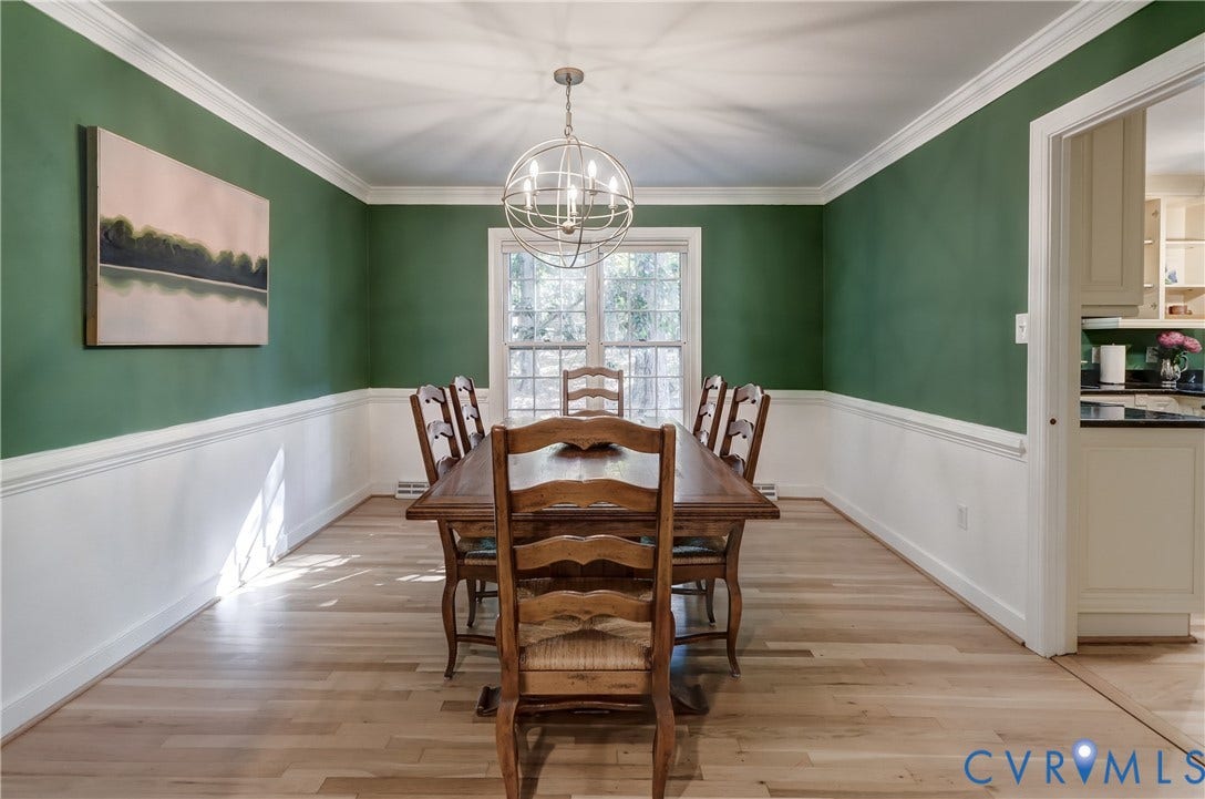 5 Bridgehampton Place, Yorkshire, Henrico, VA 23229 Dining area featuring wood-finish flooring, two-toned wall treatment with chair rail molding, crown molding, and a central spherical pendant chandelier