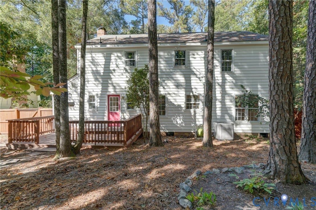 5 Bridgehampton Place, Yorkshire, Henrico, VA 23229 Two-story home exterior featuring light-colored horizontal siding, a wood-finish deck with a rail, and a wooded lot