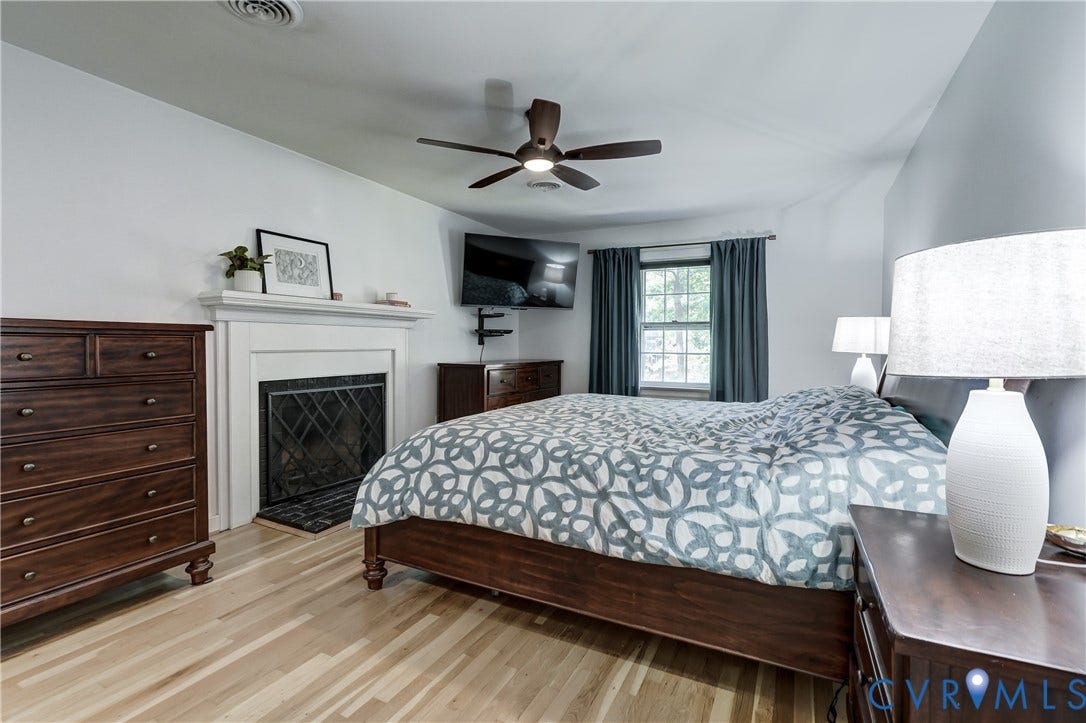 5 Bridgehampton Place, Yorkshire, Henrico, VA 23229 Wood-finish flooring, fireplace with a white mantel, and a ceiling fan