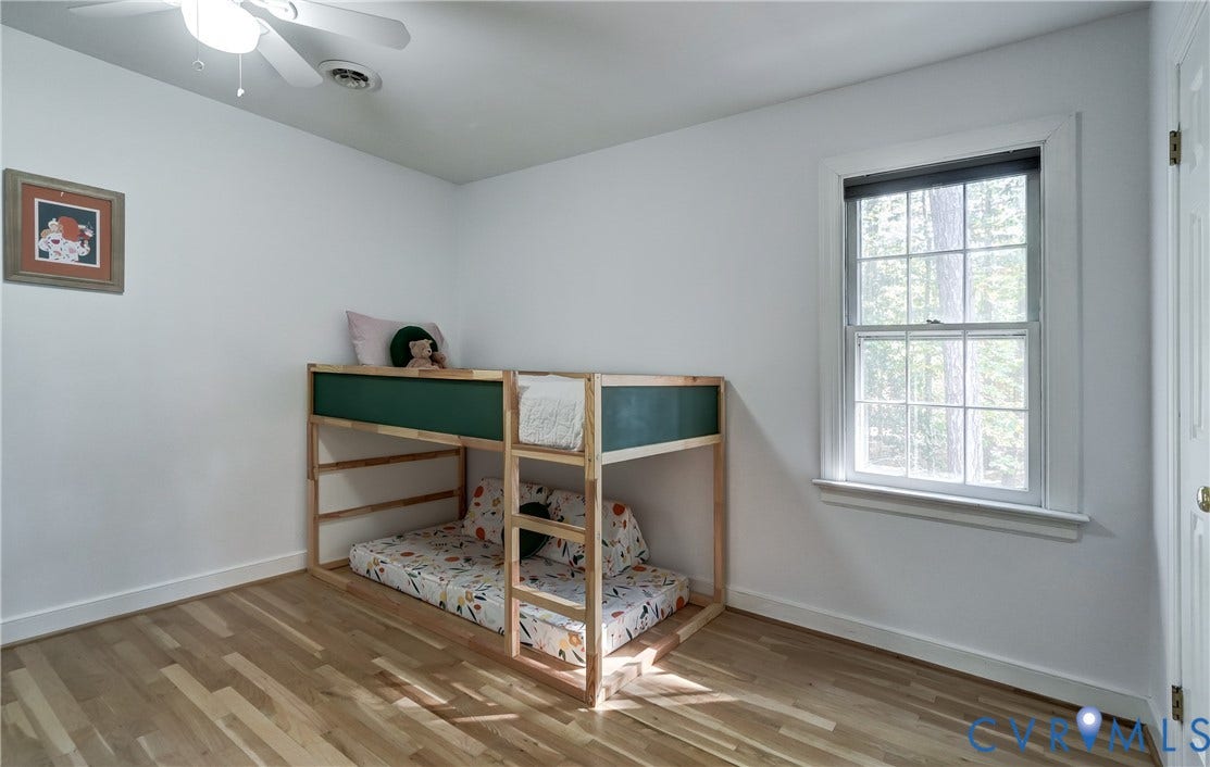 5 Bridgehampton Place, Yorkshire, Henrico, VA 23229 Room featuring wood-finish flooring, a multi-pane window, and a ceiling fan with integrated lighting