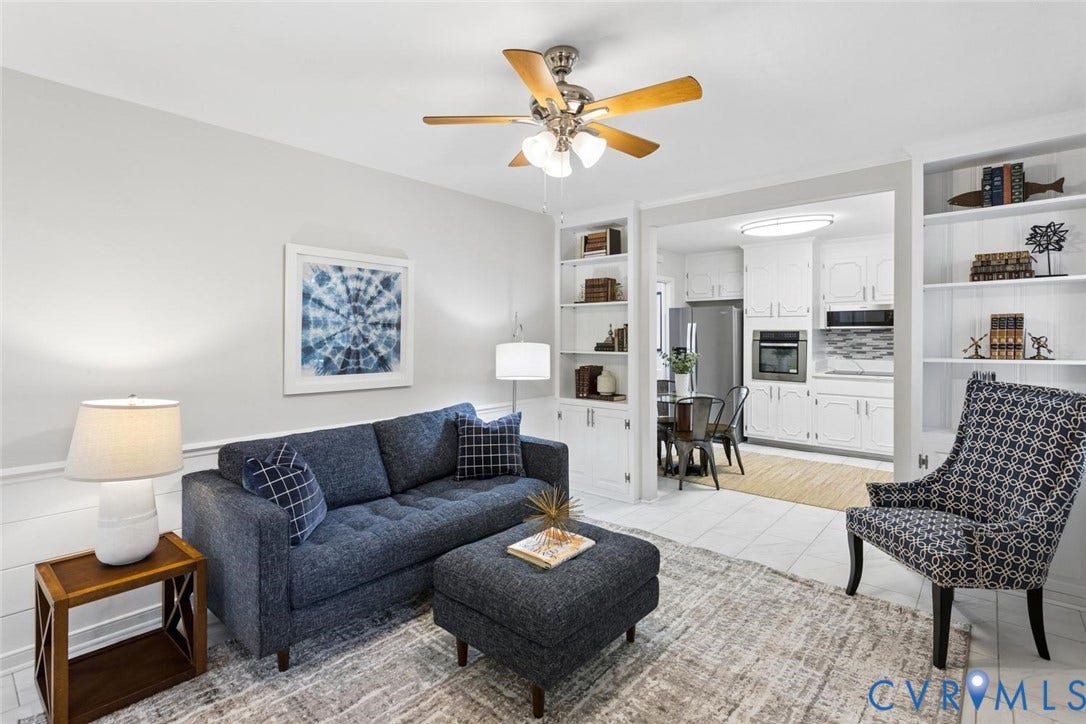 1014 Westbriar Drive, Henrico, VA 23238 Living area featuring built-in floor-to-ceiling shelving, chair rail molding, and a multi-blade ceiling fan with integrated lighting