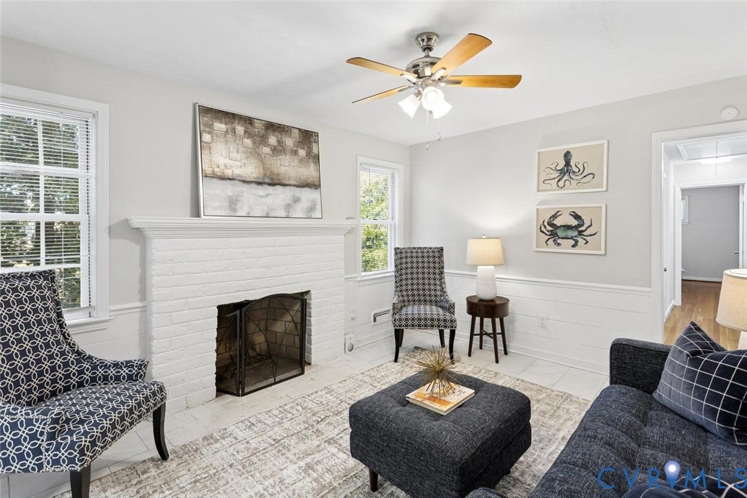 1014 Westbriar Drive, Henrico, VA 23238 Painted brick fireplace with a mantel, chair rail molding, horizontal wall paneling, and a multi-blade ceiling fan