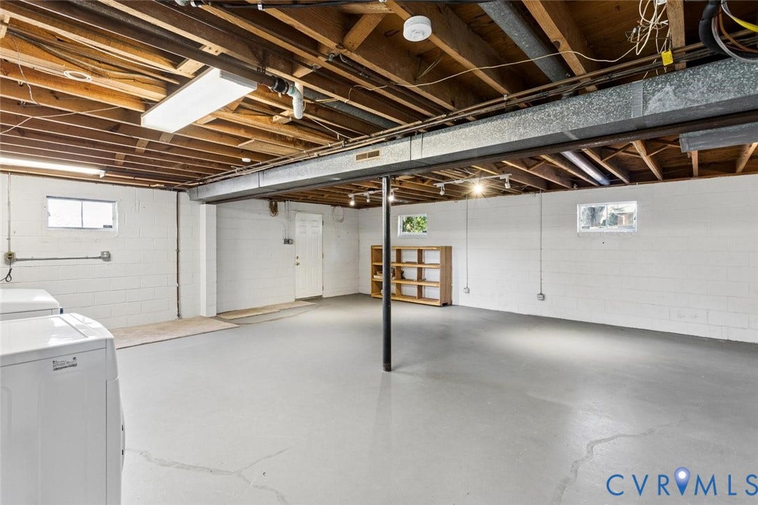1014 Westbriar Drive, Henrico, VA 23238 Unfinished lower level featuring painted concrete block walls, painted concrete flooring, exposed wood joist ceilings, and multiple windows