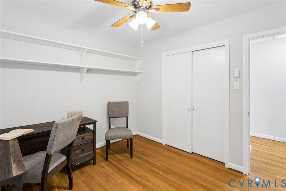 1014 Westbriar Drive, Henrico, VA 23238 Room featuring wood-finish flooring, built-in wall shelving, a sliding-door closet, and a ceiling fan with integrated lighting