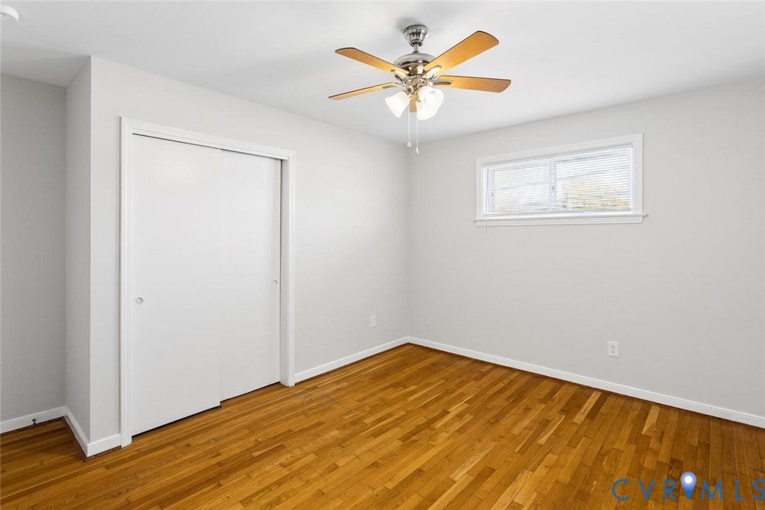 1014 Westbriar Drive, Henrico, VA 23238 Room featuring wood-finish flooring, a ceiling fan with integrated lighting, and a sliding-door closet