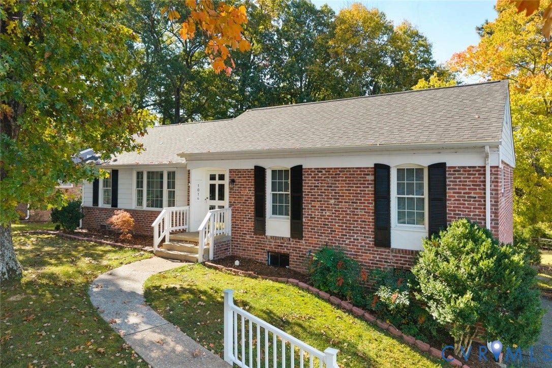 1014 Westbriar Drive, Henrico, VA 23238 Single-story brick and siding exterior featuring multi-pane windows with shutters, a paved walkway, and a covered entryway with white railing