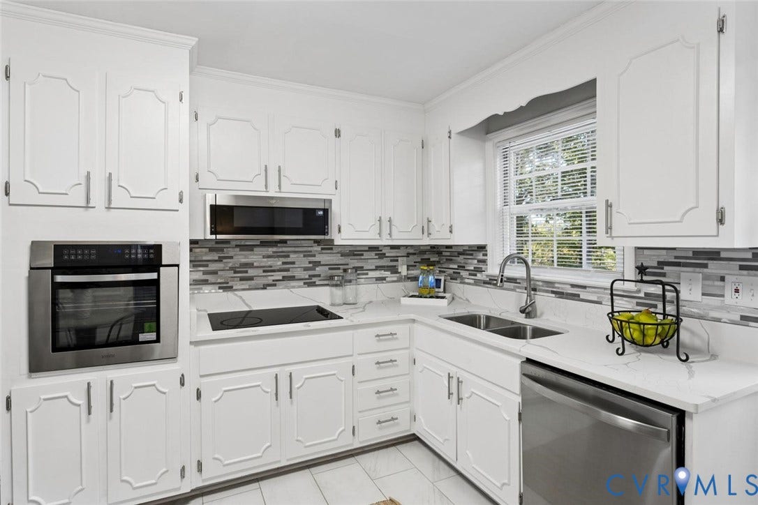 1014 Westbriar Drive, Henrico, VA 23238 Kitchen featuring white raised-panel cabinetry, stone-finish countertops, stainless steel appliances, multi-toned tiled backsplash, and tile flooring