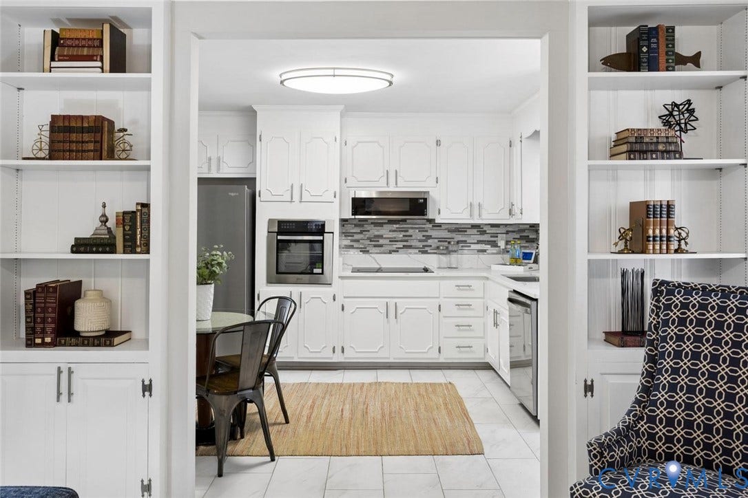 1014 Westbriar Drive, Henrico, VA 23238 Kitchen featuring white raised-panel cabinetry, stainless steel wall oven, mosaic tile backsplash, built-in floor-to-ceiling shelving, and tile flooring
