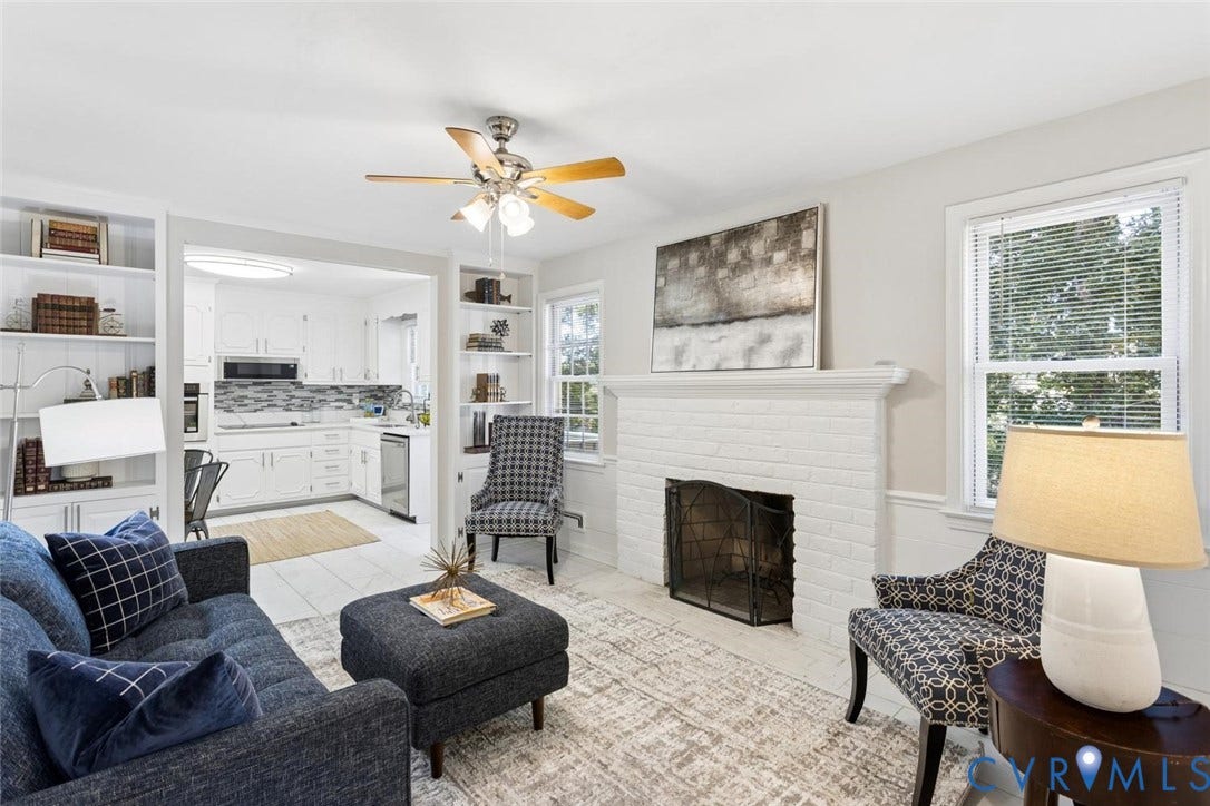 1014 Westbriar Drive, Henrico, VA 23238 Living area featuring a white brick fireplace with a custom mantle, built-in floor-to-ceiling shelving, and a ceiling fan