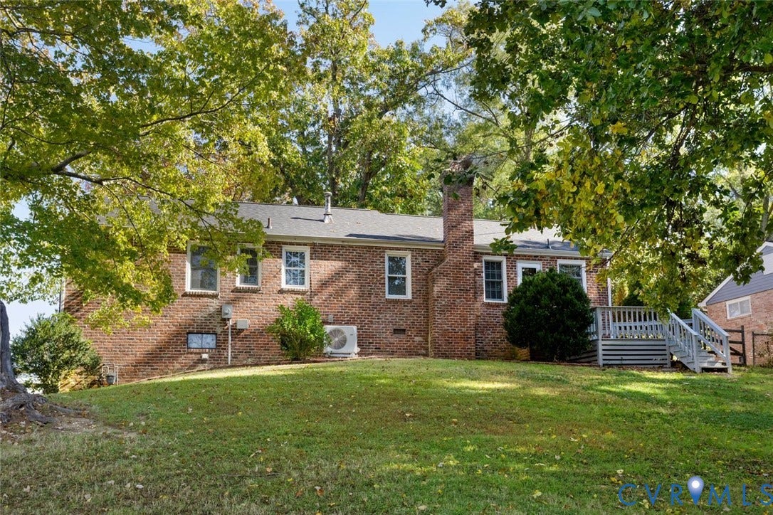 1014 Westbriar Drive, Henrico, VA 23238 Brick exterior featuring an elevated wood deck, exterior chimney, and mature trees situated on a sloped lot