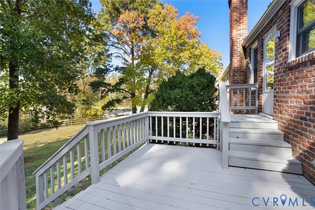 1014 Westbriar Drive, Henrico, VA 23238 Elevated deck featuring painted wood-finish railing and stairs, exterior brick masonry, and a chimney stack