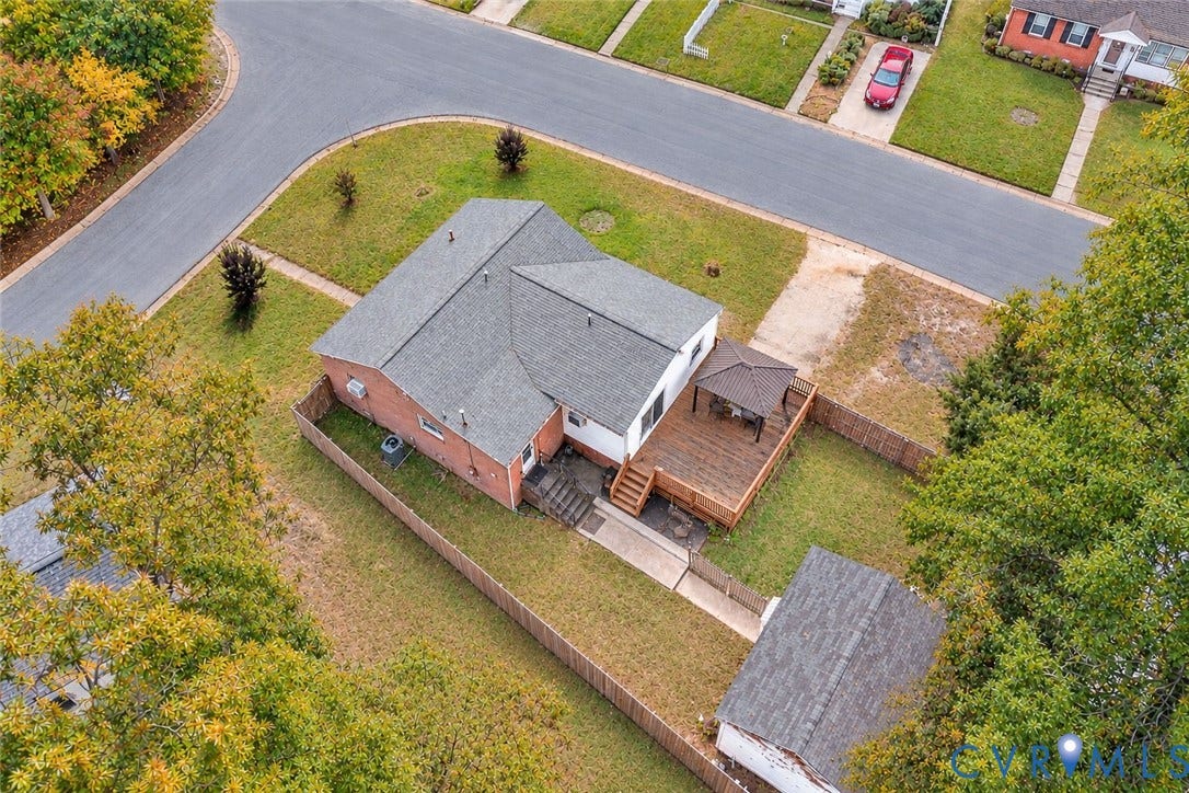 628 Ryan Avenue, Ryan, Colonial Heights, VA 23834 Single-story residence featuring a red brick exterior, dark-toned shutters, a gabled roofline, and an expansive lawn