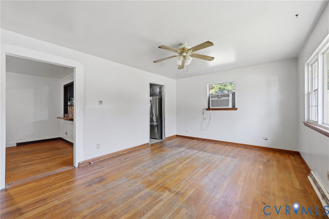 628 Ryan Avenue, Ryan, Colonial Heights, VA 23834 Interior space featuring hardwood flooring, natural light from double-hung windows, and a ceiling-mounted light fixture with a fan