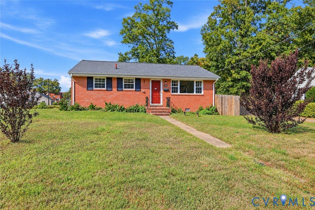 628 Ryan Avenue, Ryan, Colonial Heights, VA 23834 Single-story brick exterior featuring a shingled roof, contrasting dark shutters, and a central red entrance door