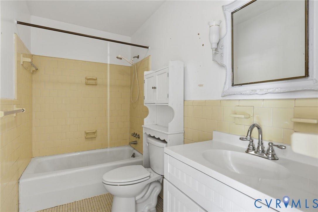628 Ryan Avenue, Ryan, Colonial Heights, VA 23834 Bathroom featuring a porcelain tub and shower combination with tiled surround, integrated vanity with a basin sink, and wall-mounted mirror
