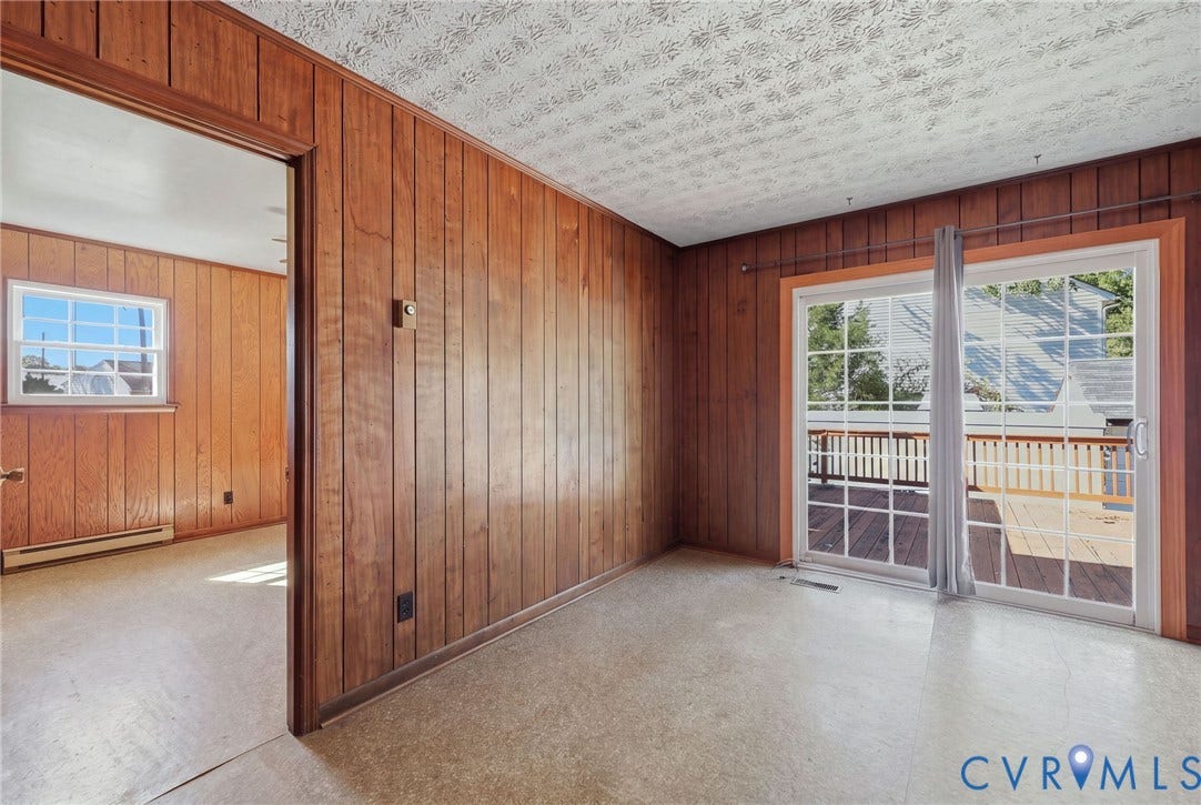 628 Ryan Avenue, Ryan, Colonial Heights, VA 23834 Wood-panelled interior walls, sliding glass door with grid muntins, and access to an exterior deck