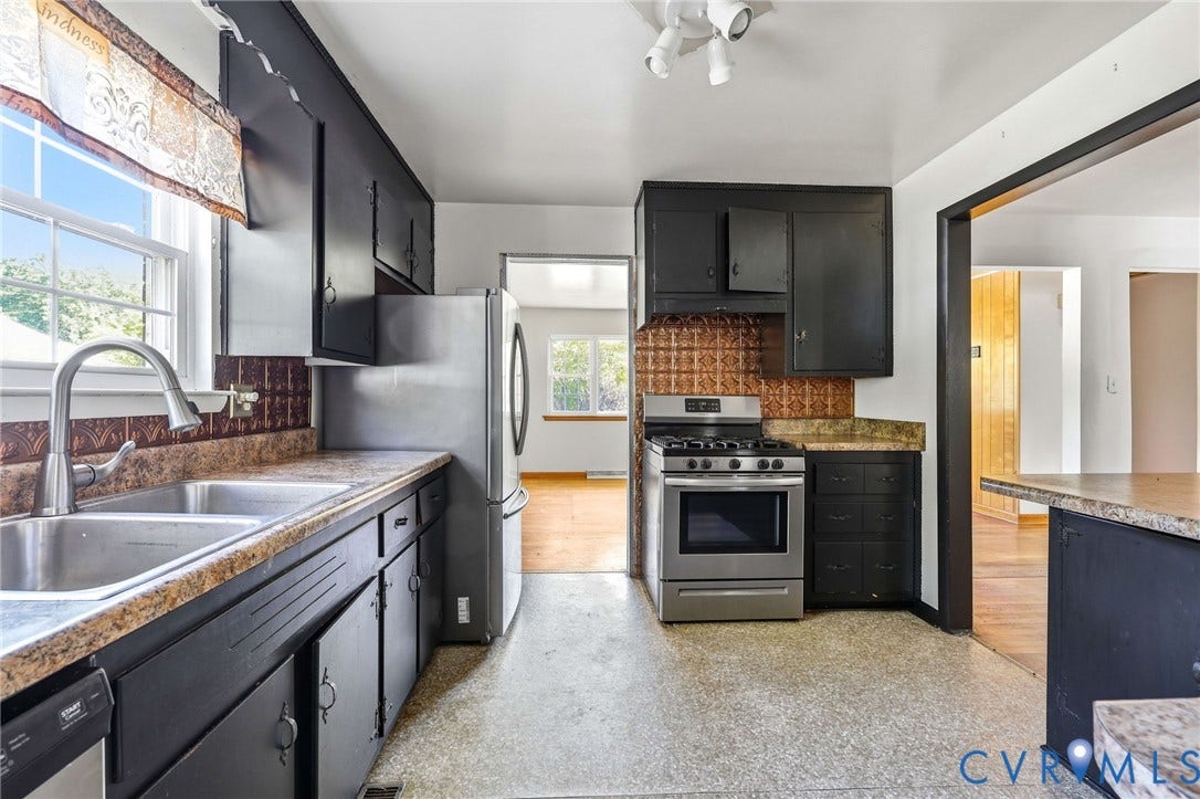 628 Ryan Avenue, Ryan, Colonial Heights, VA 23834 Kitchen featuring dark cabinetry, stainless steel appliances, decorative backsplash, and stone-finish countertops with an integrated dual-basin sink