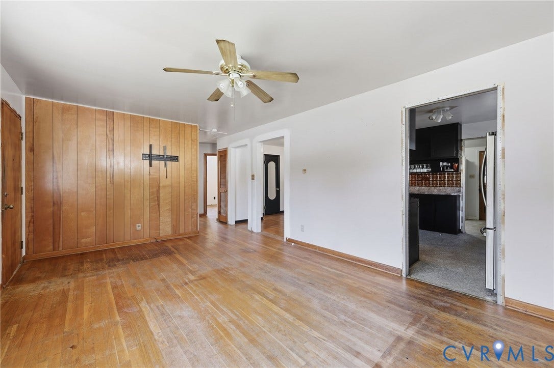 628 Ryan Avenue, Ryan, Colonial Heights, VA 23834 Interior space featuring wood-paneled accent wall, wood-finish flooring, and ceiling-mounted fan with integrated lighting