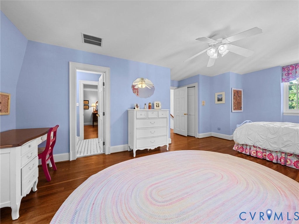 105 Running Cedar Lane, Countryside, Henrico, VA 23229 Bedroom featuring polished wood-finish flooring, a multi-blade ceiling fan with integrated light fixture, and two panel-door closets
