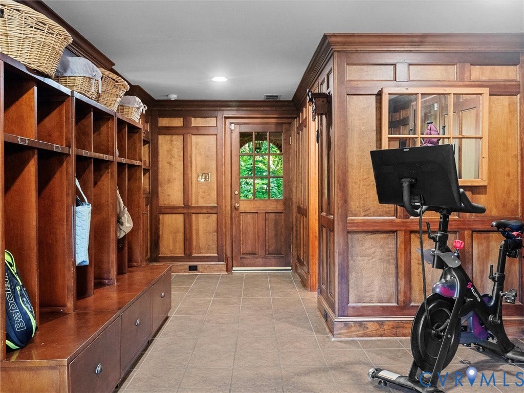105 Running Cedar Lane, Countryside, Henrico, VA 23229 Custom wood paneling, extensive built-in cabinetry with individual storage cubbies, and a wood entry door featuring multi-pane glass inserts and an arched top