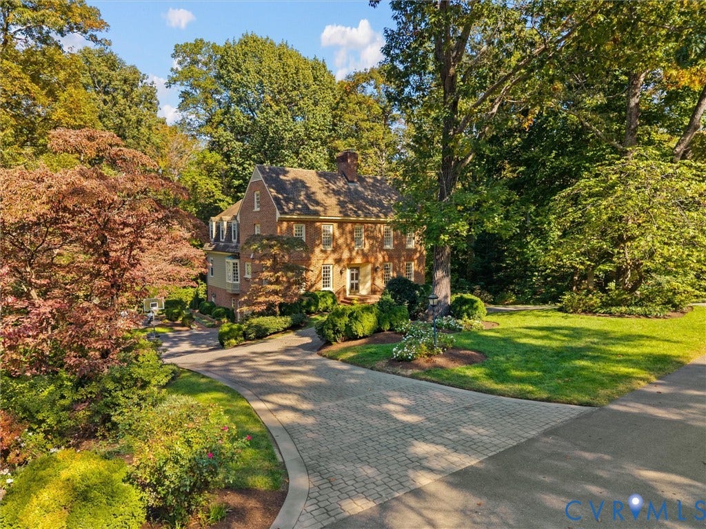 105 Running Cedar Lane, Countryside, Henrico, VA 23229 Brick exterior Colonial-style residence featuring a multi-gabled roofline, dormer windows, a paved stone driveway, and established landscaping