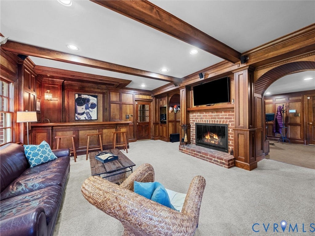 105 Running Cedar Lane, Countryside, Henrico, VA 23229 Extensive wood paneling featuring coffered ceiling beams, a built-in bar, a masonry brick fireplace, and arched doorways