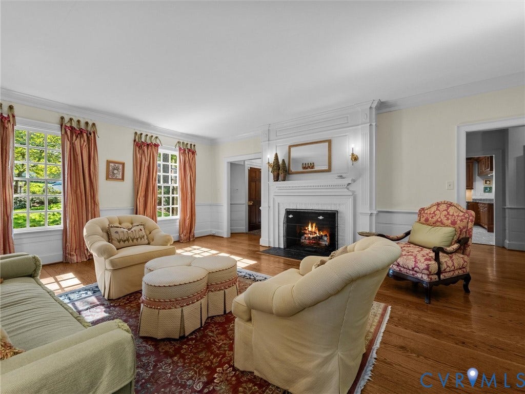 105 Running Cedar Lane, Countryside, Henrico, VA 23229 Living room featuring a classic fireplace with white wood mantel and paneling, hardwood flooring, multi-pane windows, and chair rail millwork