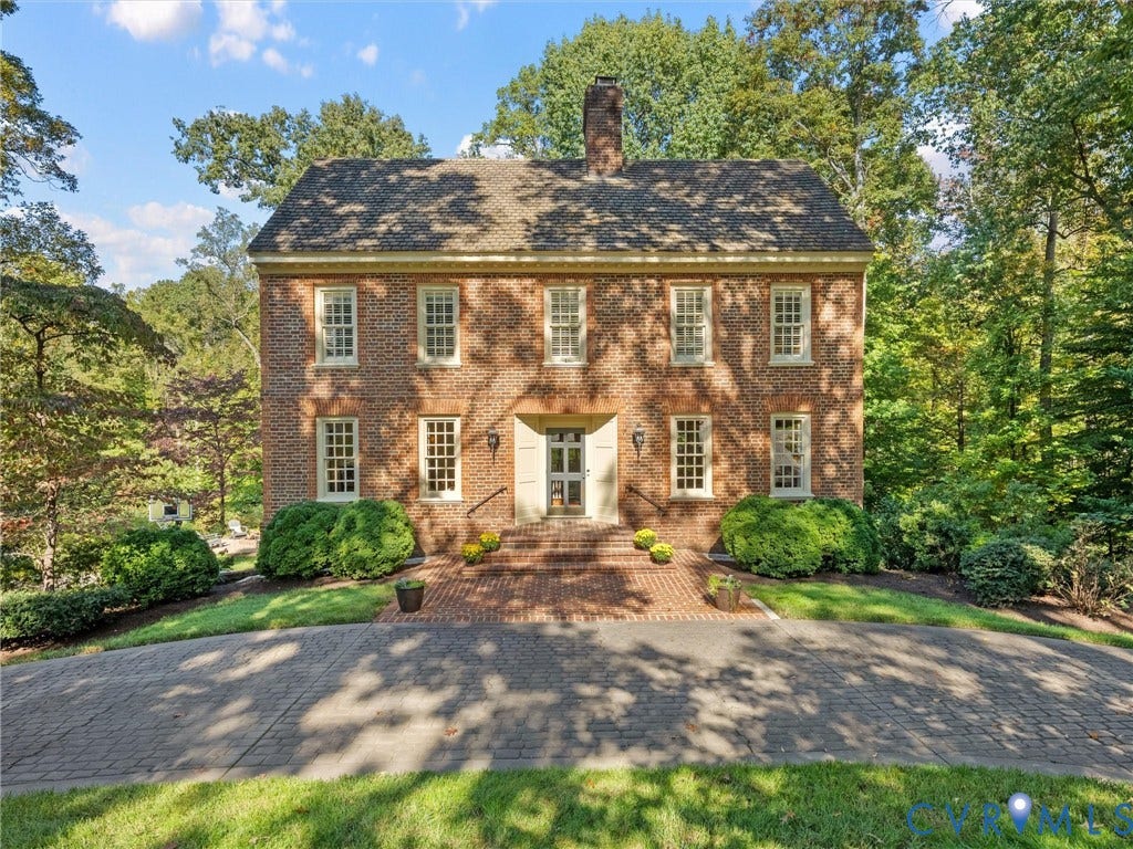 105 Running Cedar Lane, Countryside, Henrico, VA 23229 Traditional brick exterior featuring a central chimney, symmetrical multi-pane windows, a detailed cornice, and a brick-paved entry path