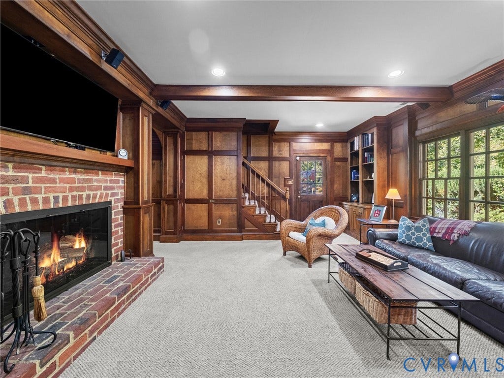 105 Running Cedar Lane, Countryside, Henrico, VA 23229 Custom wood-paneled walls, exposed ceiling beams, built-in shelving, brick fireplace surround, and multi-pane windows