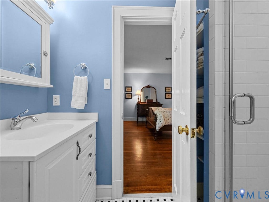 105 Running Cedar Lane, Countryside, Henrico, VA 23229 Bathroom featuring a white vanity cabinet with a solid surface countertop, chrome faucet, medicine cabinet, and a glass-enclosed shower with white subway tile surround