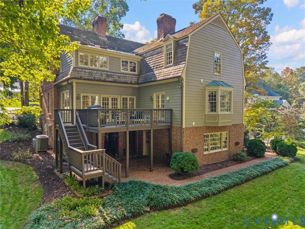 105 Running Cedar Lane, Countryside, Henrico, VA 23229 Multi-story Dutch Colonial exterior featuring a combination of brick and horizontal siding, a raised wooden deck, a lower-level brick patio, and a bay window