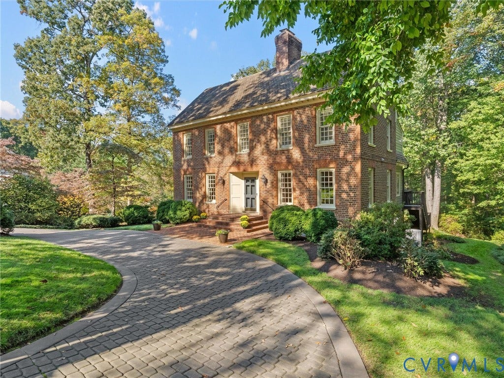 105 Running Cedar Lane, Countryside, Henrico, VA 23229 Two-story brick exterior featuring a multi-pane window configuration, a central chimney, and a paved circular driveway leading to a brick-accented entryway