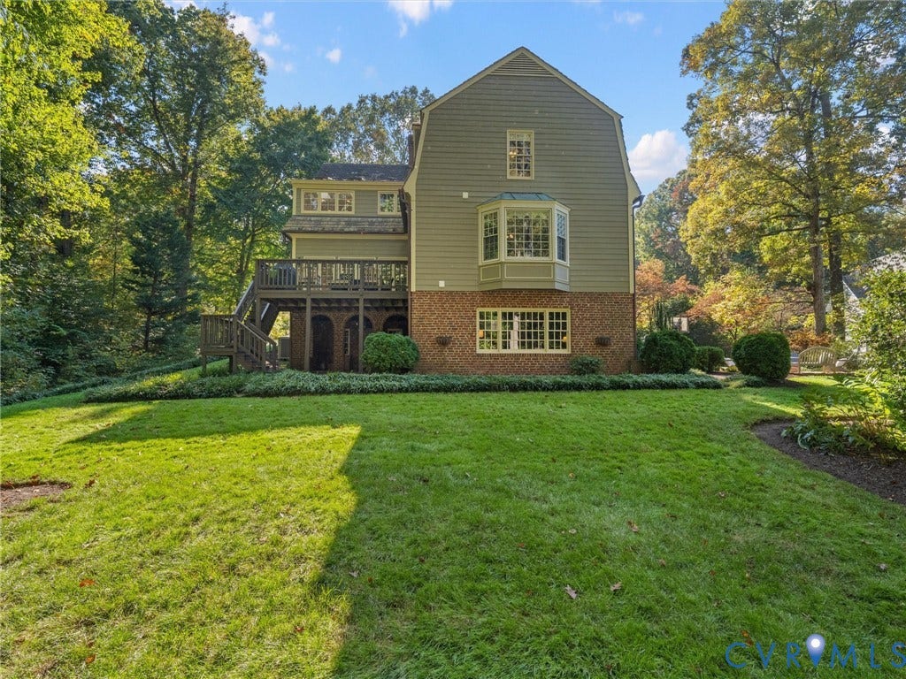 105 Running Cedar Lane, Countryside, Henrico, VA 23229 Multi-level exterior featuring a brick and horizontal siding facade, a raised wooden deck with stairs, a multi-pane bay window, and a spacious lawn