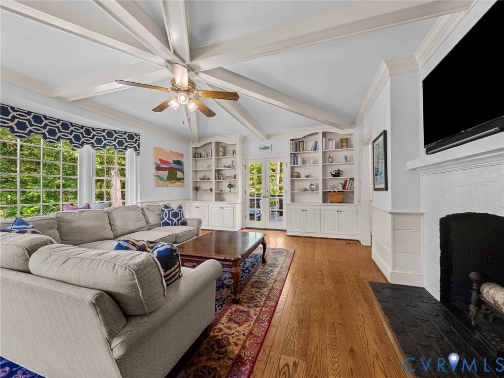 105 Running Cedar Lane, Countryside, Henrico, VA 23229 Vaulted ceiling featuring exposed beams, wood-finish flooring, built-in cabinetry, and a fireplace with a black masonry hearth