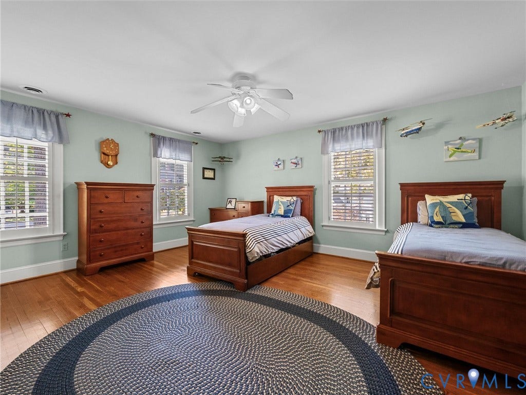 105 Running Cedar Lane, Countryside, Henrico, VA 23229 Spacious room featuring wood-finish flooring, three double-hung windows, and a ceiling-mounted light fixture with a central fan