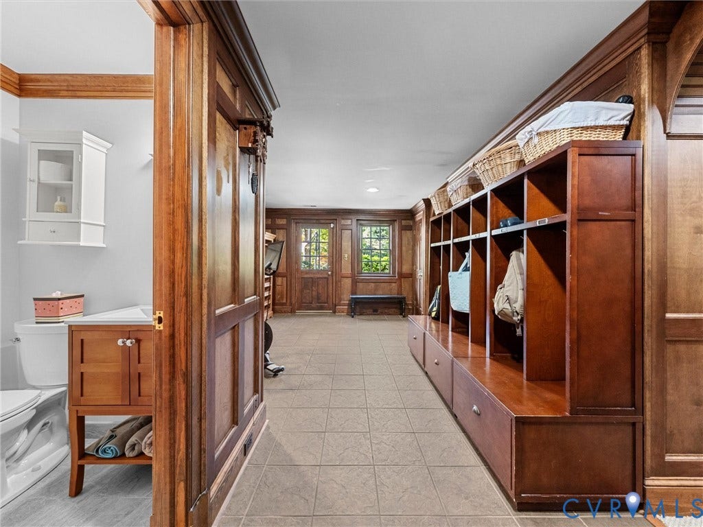 105 Running Cedar Lane, Countryside, Henrico, VA 23229 Custom wood paneling, built-in floor-to-ceiling cabinetry, tile flooring, and a vanity with a wall-mounted cabinet
