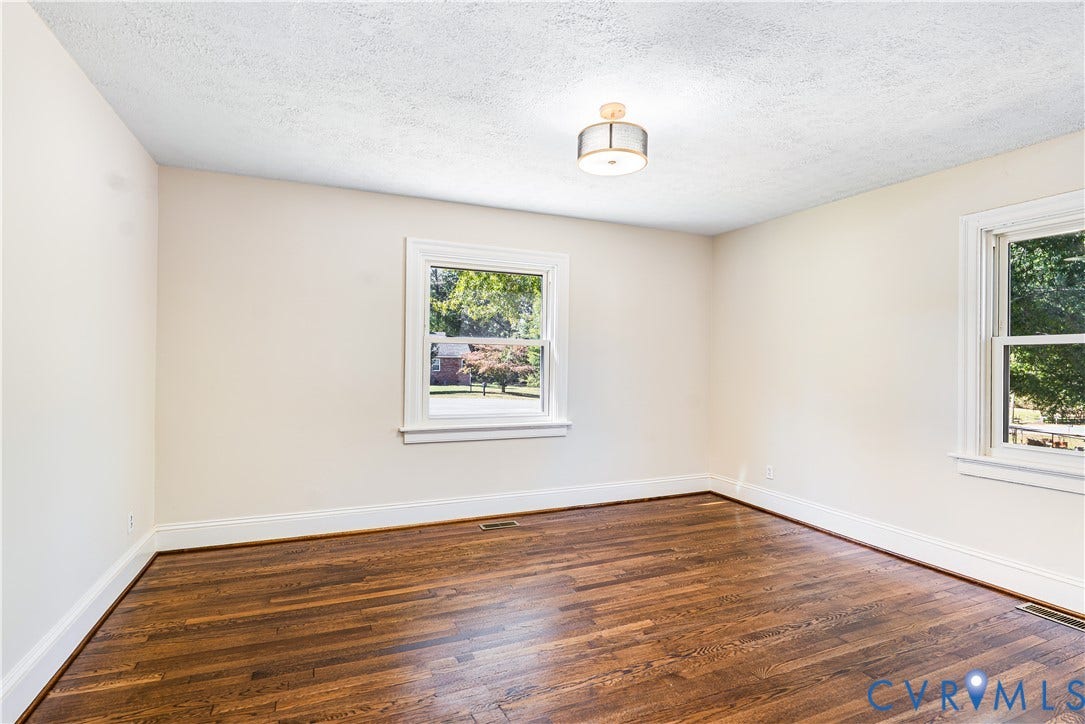 4003 Lee Boulevard, Dinwiddie, VA 23803 Room with wood-finish flooring, two double-hung windows, and a flush-mount drum ceiling light fixture