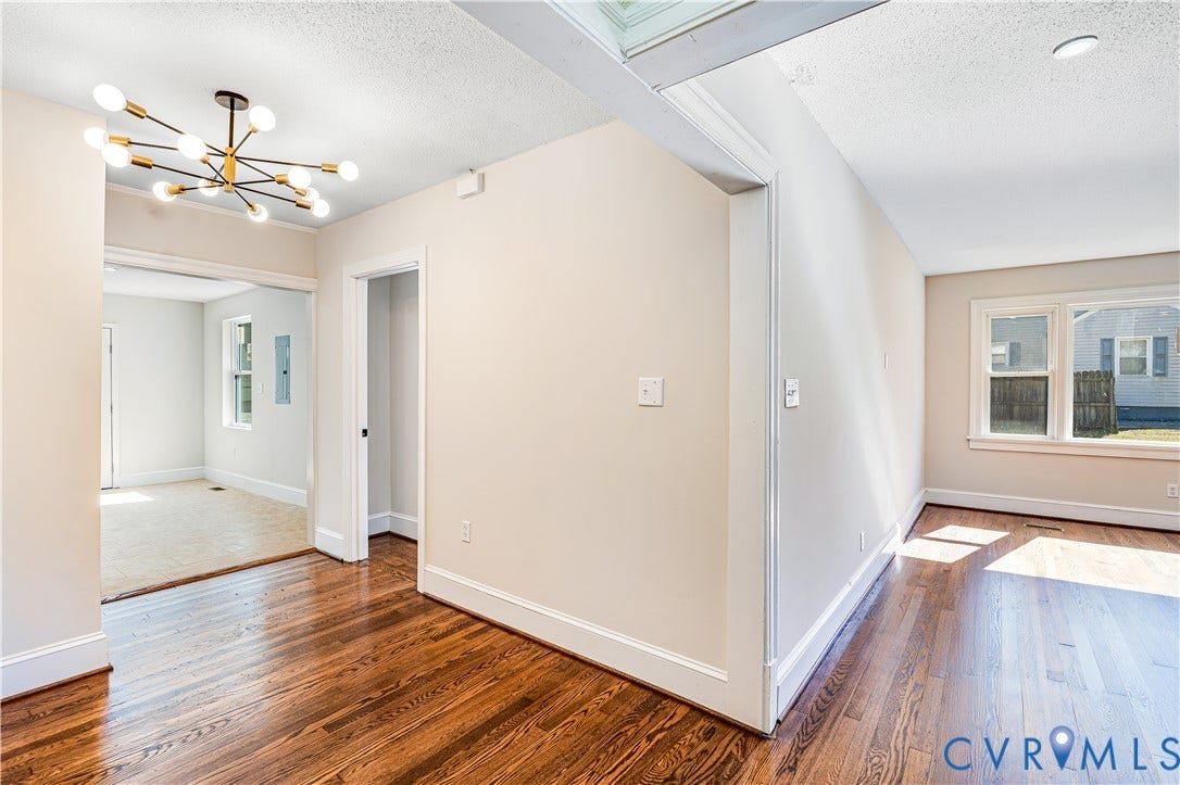 4003 Lee Boulevard, Dinwiddie, VA 23803 Interior featuring wood-finish flooring, a contemporary multi-arm chandelier, neutral wall paint, and double-hung windows