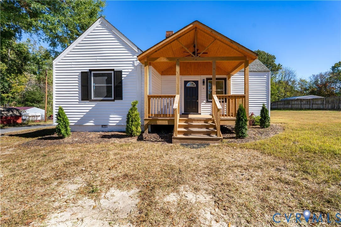4003 Lee Boulevard, Dinwiddie, VA 23803 Exterior featuring white horizontal siding, dark window shutters, and a covered front porch with wood-finished ceiling and railing