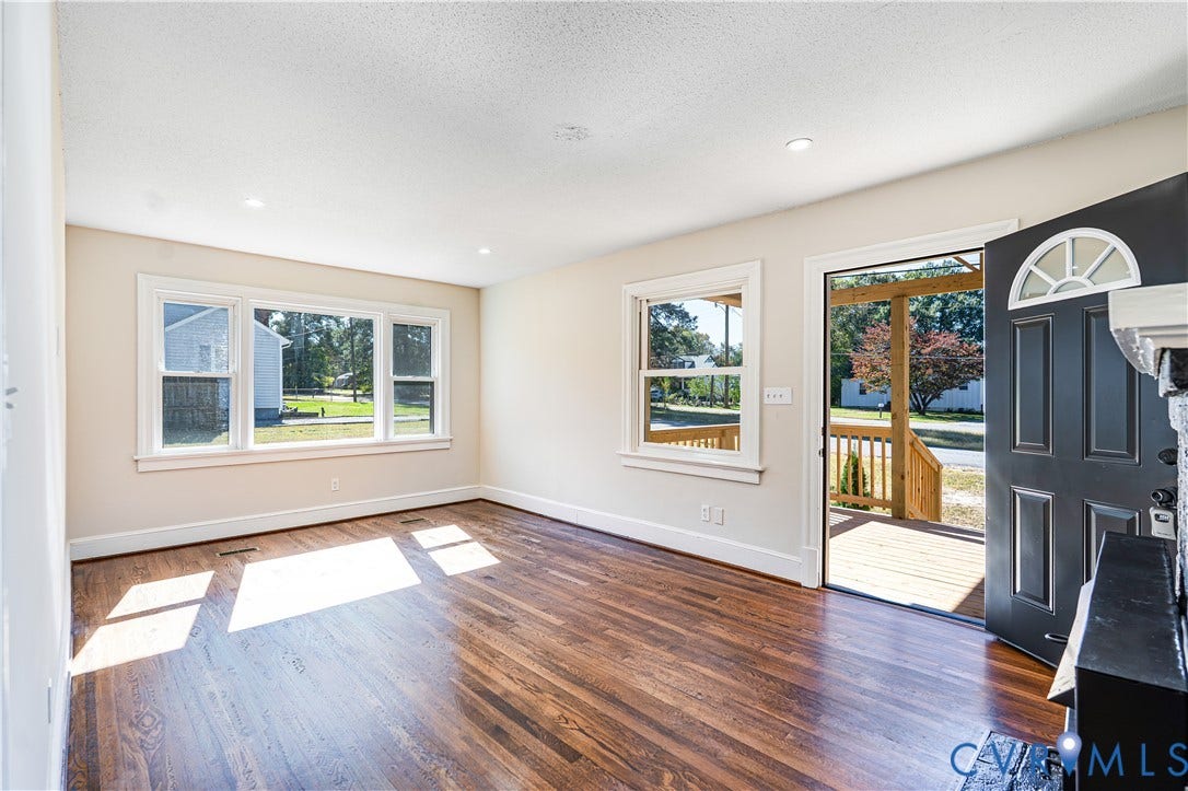4003 Lee Boulevard, Dinwiddie, VA 23803 Interior space featuring wood-finish flooring, recessed lighting, multi-pane windows, and a dark-finished entry door with an arched transom window