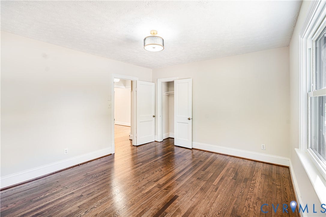 4003 Lee Boulevard, Dinwiddie, VA 23803 Room featuring wood-finish flooring, a drum-style ceiling light fixture, multi-panel doors, and a reach-in closet