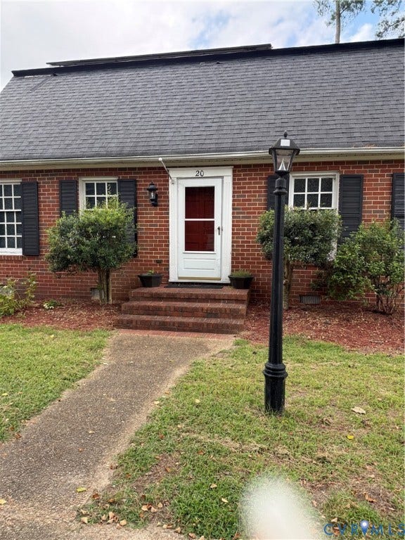 20 Jonquil Lane, Newport News, VA 23606 Brick exterior featuring dark shutters, a front entry with brick steps, and an integrated lamp post