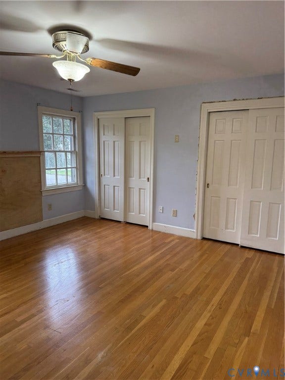20 Jonquil Lane, Newport News, VA 23606 Room featuring wood-finish flooring, two sets of multi-panel sliding closet doors, a multi-pane window, and a central ceiling fan with integrated lighting