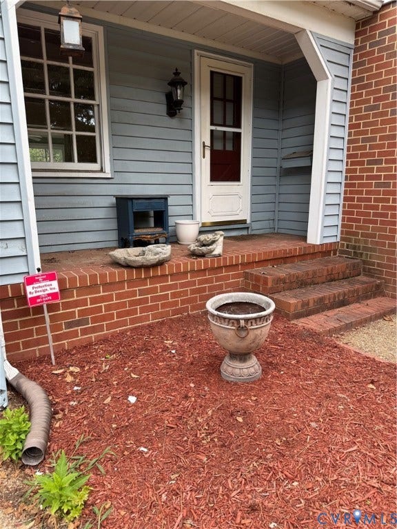 20 Jonquil Lane, Newport News, VA 23606 Covered front porch featuring brick masonry steps, horizontal siding, and classic exterior wall-mounted lighting